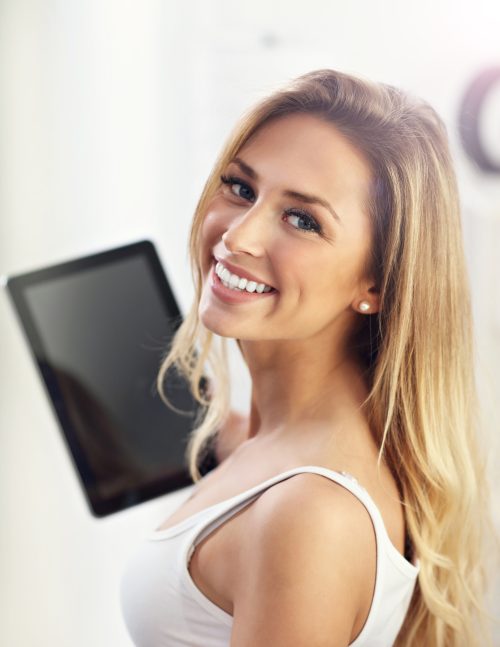 a woman holding a tablet - No Upfront Costs